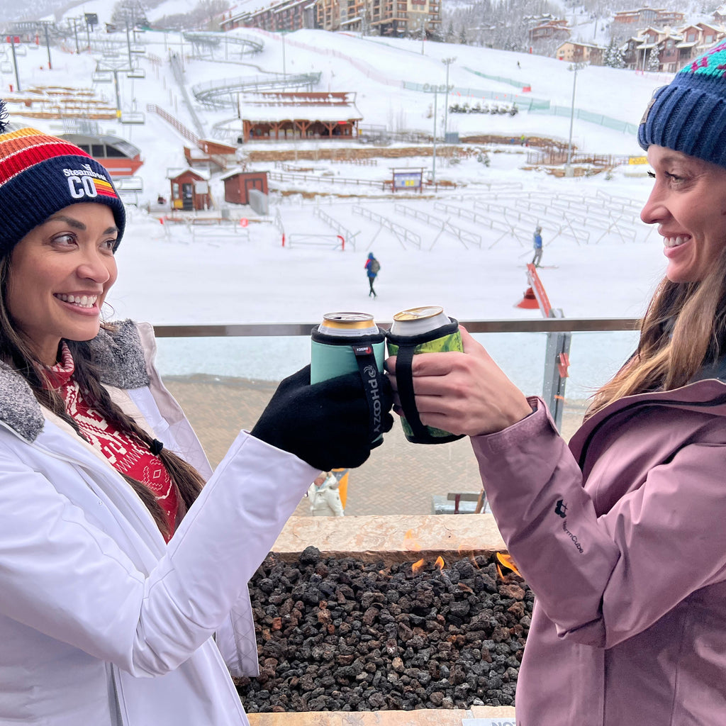 Friends toasting drinks at a ski resort bar